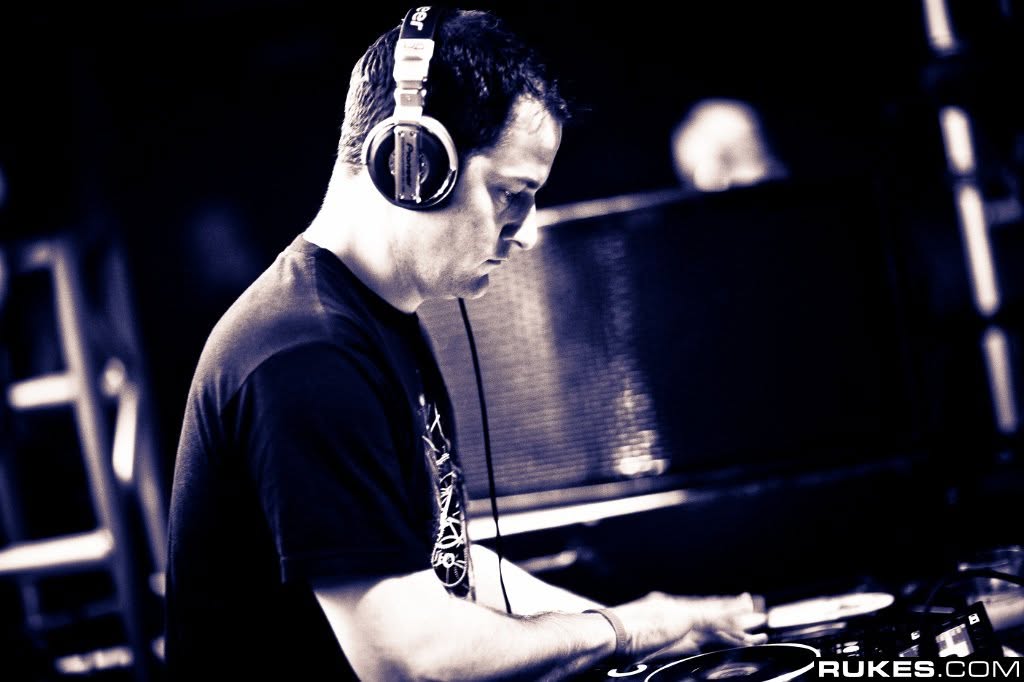 Josh Tone in headphones playing a DJ set, in sepia tones